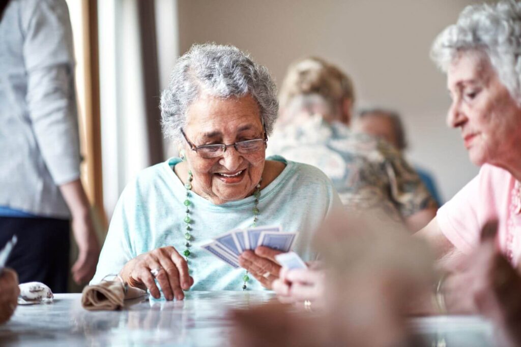 assisted living residents enjoying a game of cards